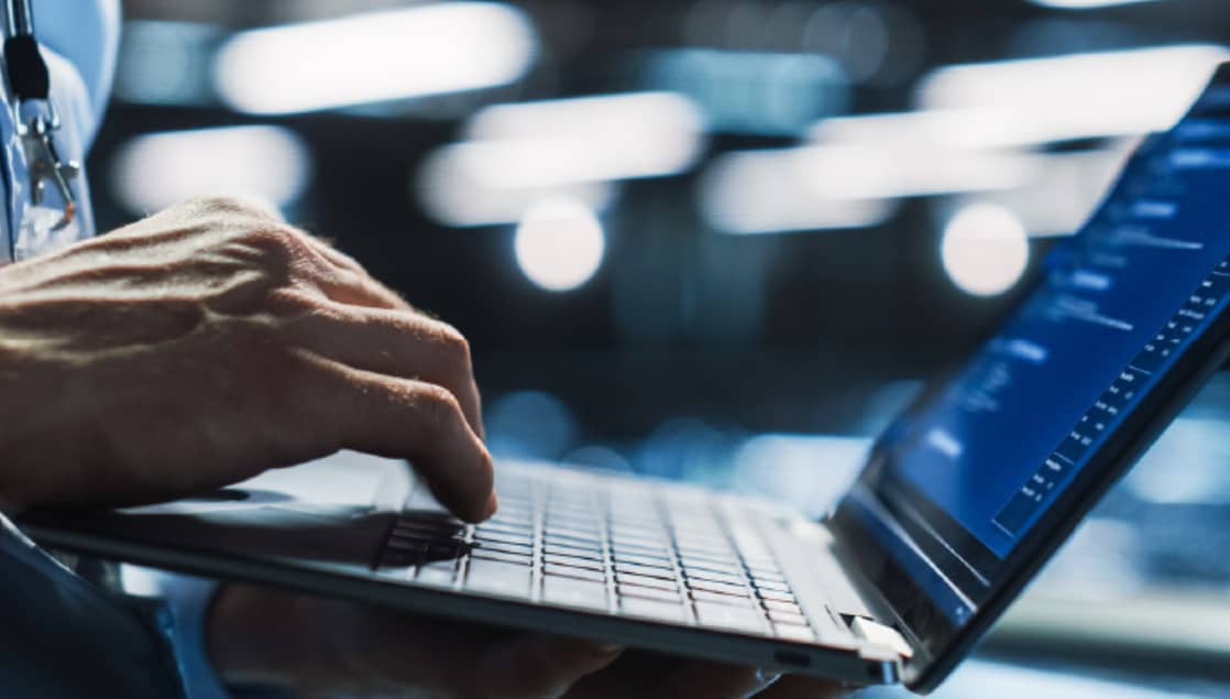 hand on laptop keyboard